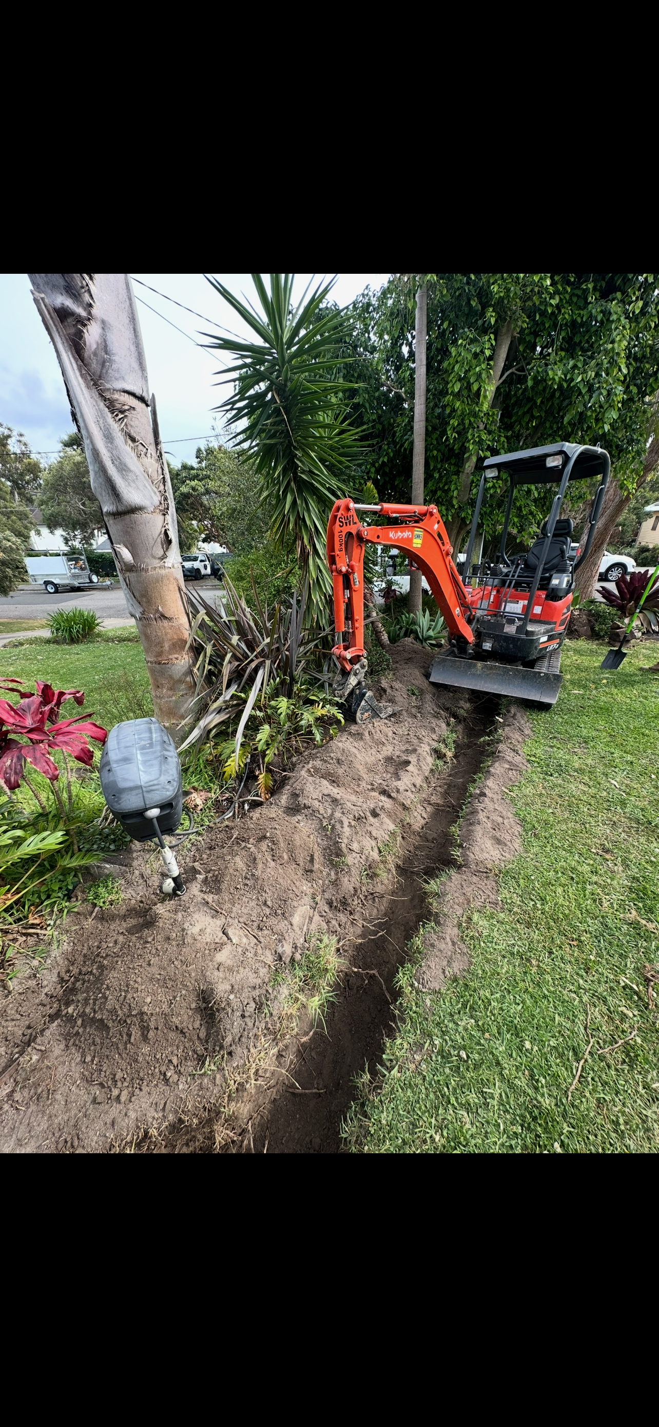 Excavator digging a trench